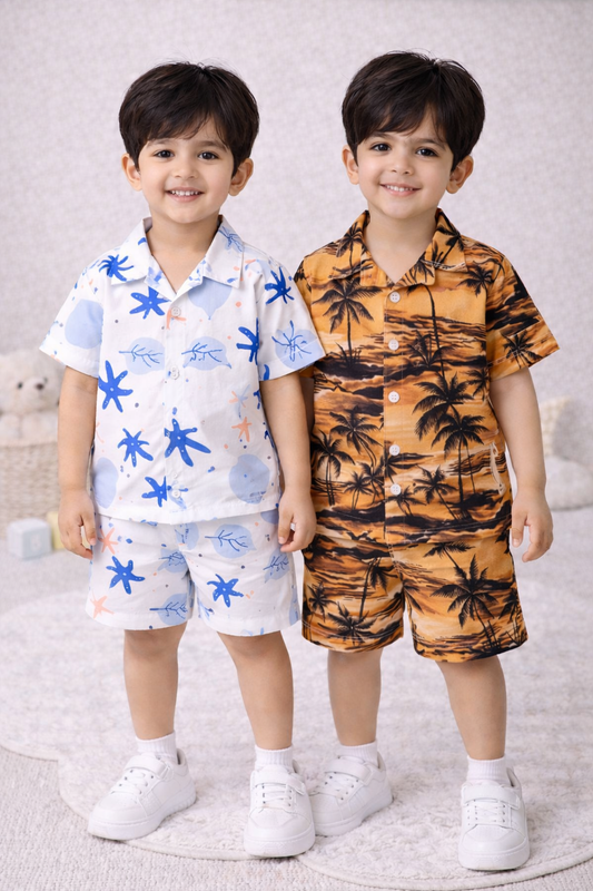 "Two young boys wearing matching summer sets, smiling, studio setting."